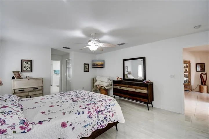 Bedroom with ceiling fan and baseboards