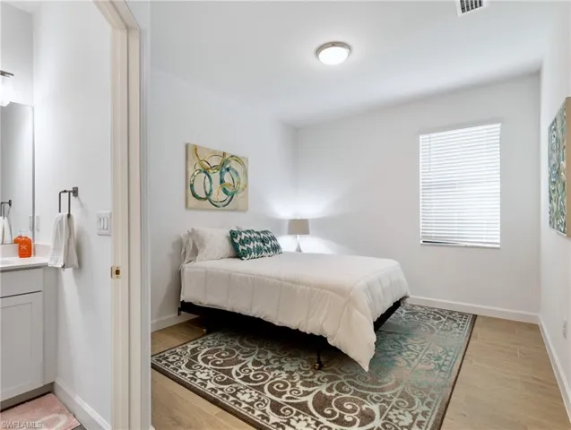 Bedroom with light hardwood / wood-style flooring