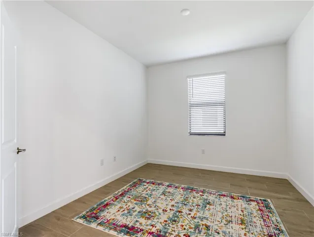 Unfurnished room with hardwood / wood-style flooring
