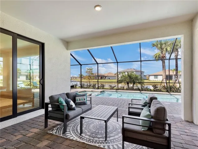 View of patio with an outdoor living space and glass enclosure