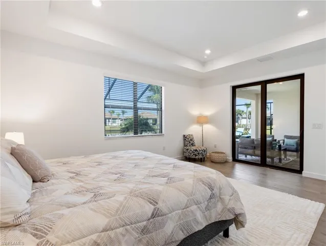 Bedroom with wood-type flooring and access to exterior