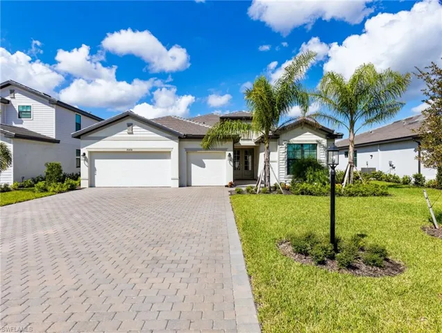 View of front facade with a front yard and a garage