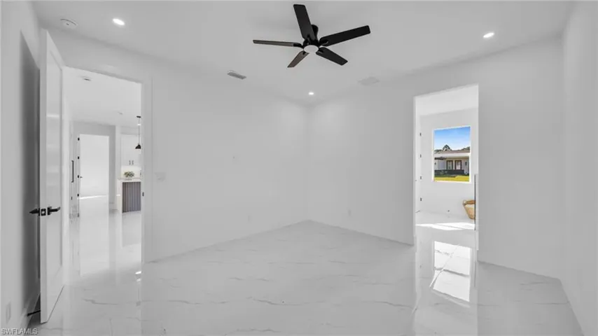 Spare room featuring light marble finish floors, recessed lighting, and ceiling fan