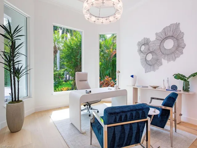 Dedicated room featuring light wood-finish flooring, white walls, and an ornate ceiling fixture