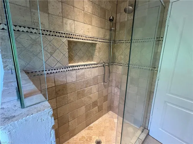 Full bathroom with tiled shower