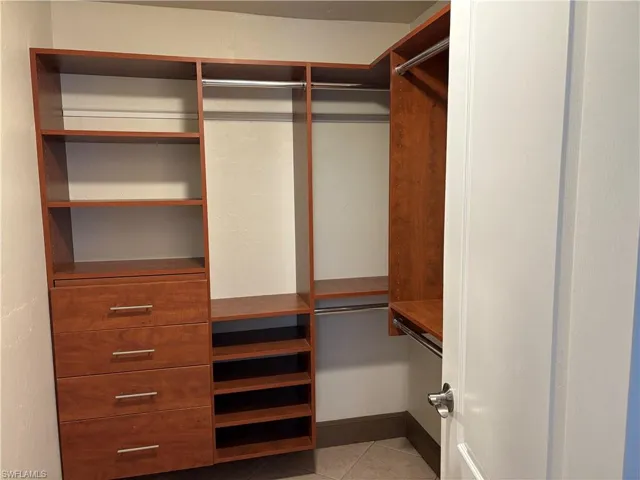 Spacious closet with light tile patterned flooring
