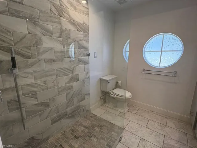 Full bathroom with baseboards and walk in shower