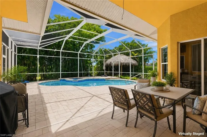 Screened lanai featuring a swimming pool and built-in spa