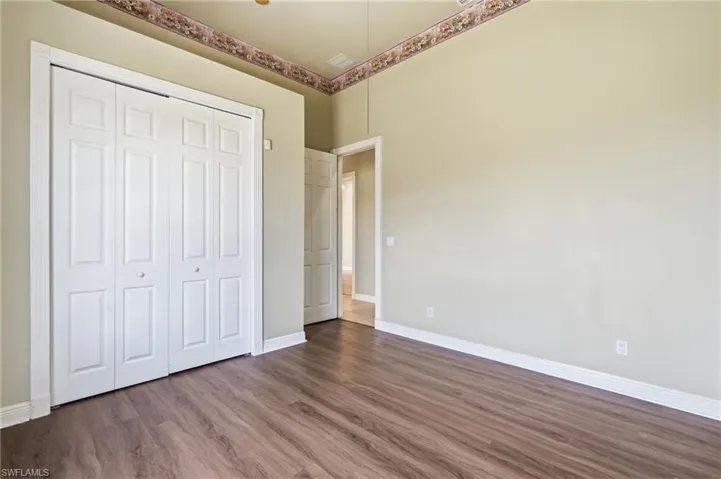 Wood-finish flooring throughout, complemented by white baseboards and neutral wall tones