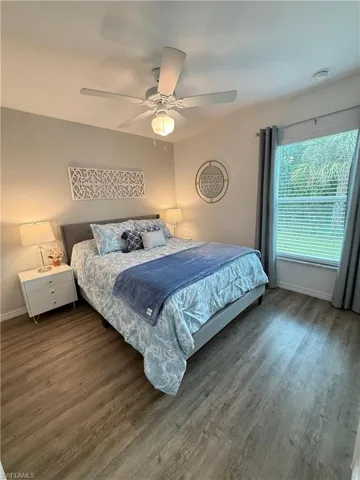 Bedroom with wood finished floors and a ceiling fan