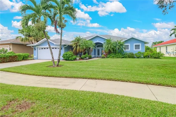 Ranch-style home with a front lawn, stucco siding, and an attached garage