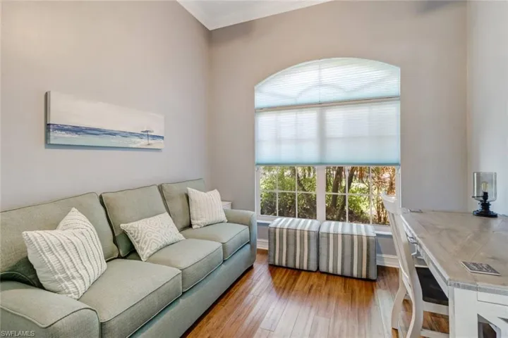 Living area featuring hardwood / wood-style flooring and crown molding