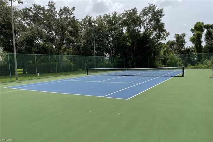 View of tennis court with community basketball court