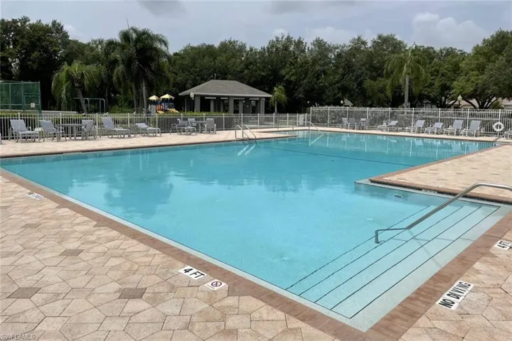Community pool with a patio