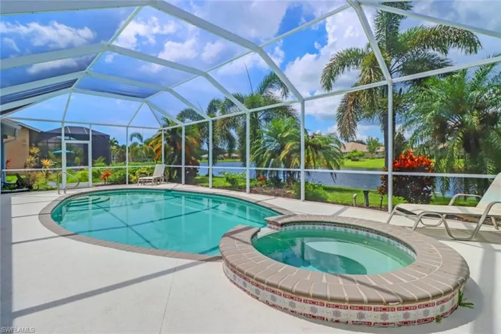 Integrated pool / hot tub with a patio area, a sunroom, and glass enclosure