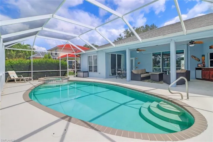 Integrated pool / hot tub featuring a sunroom, a patio area, an outdoor hangout area, and a lanai