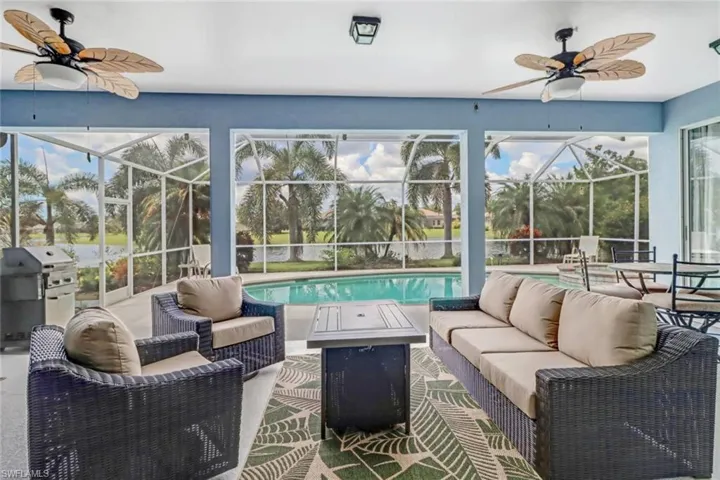 View of patio with outdoor furniture, a ceiling fan, a sunroom, and area for grilling