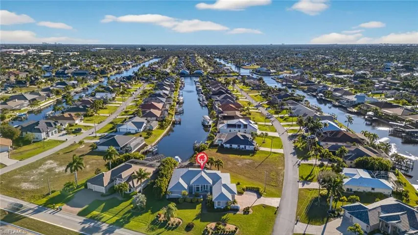 Aerial view of property's location with nearby suburban area and a nearby body of water