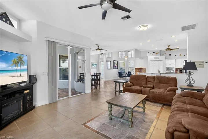 Living room featuring light tile patterned floors and baseboards
