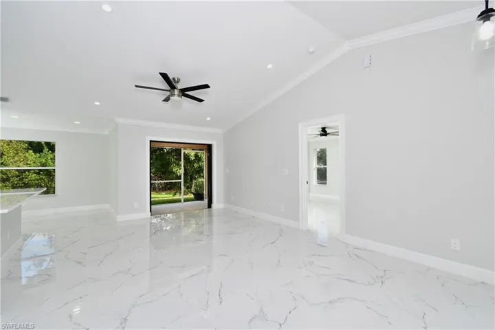Unfurnished room with baseboards, ornamental molding, and a ceiling fan