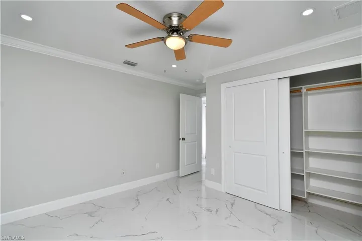 Unfurnished bedroom with baseboards, visible vents, ornamental molding, and recessed lighting