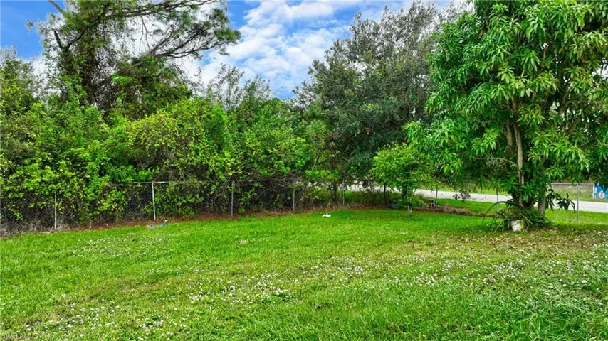 View of yard featuring fence