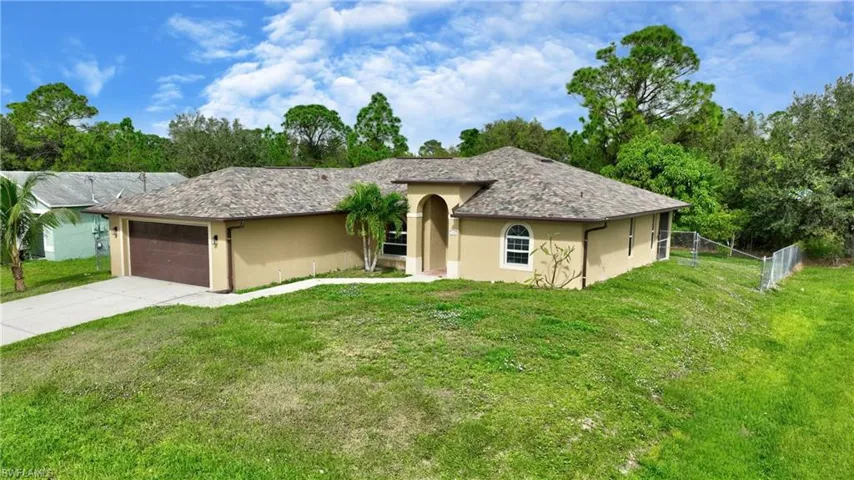 Single story home featuring fence, a front yard, stucco siding, and an attached garage