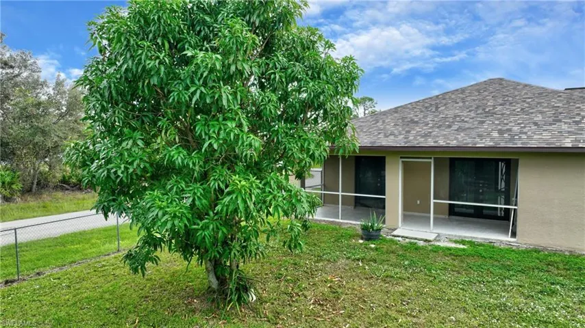 View of yard with a sunroom and fence