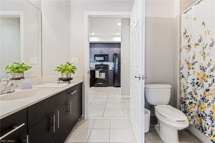 Bathroom featuring tile flooring, vanity, and toilet