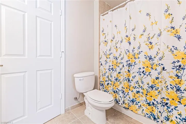 Bathroom with toilet and tile floors
