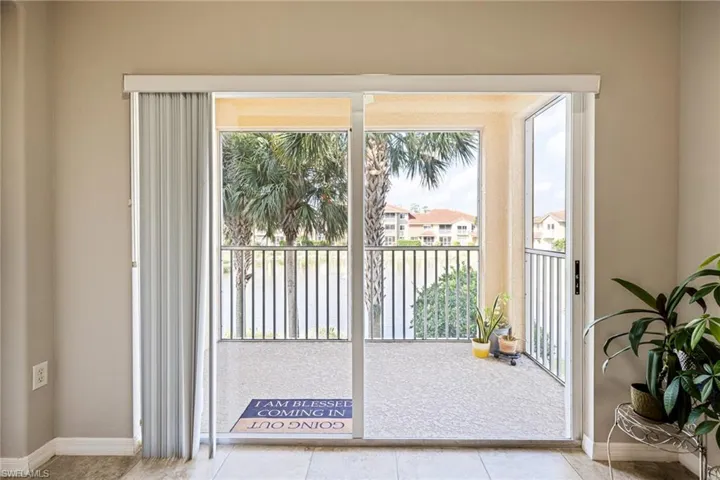 Doorway featuring plenty of natural light and light tile flooring