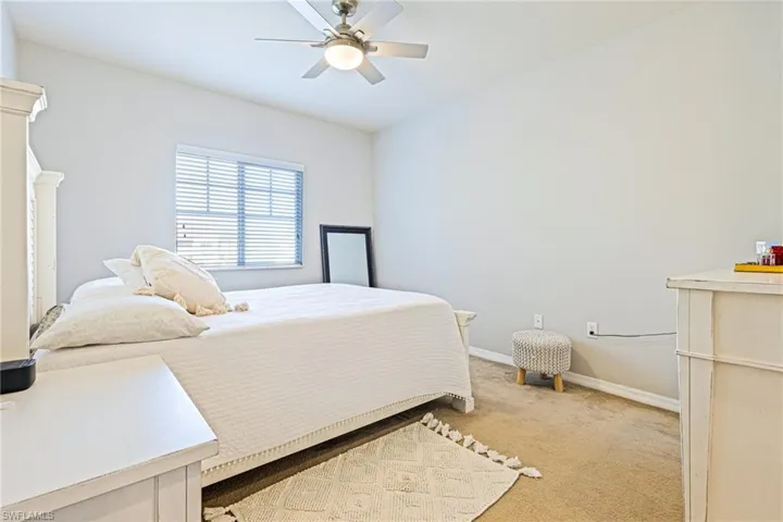 Bedroom featuring ceiling fan and light carpet
