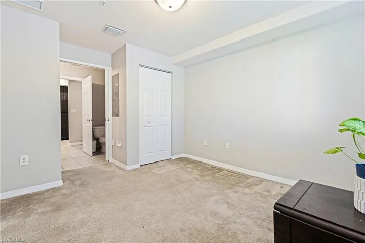 Unfurnished bedroom featuring light carpet