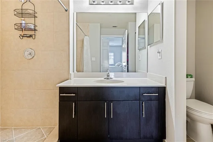 Bathroom with tile floors, vanity, and toilet