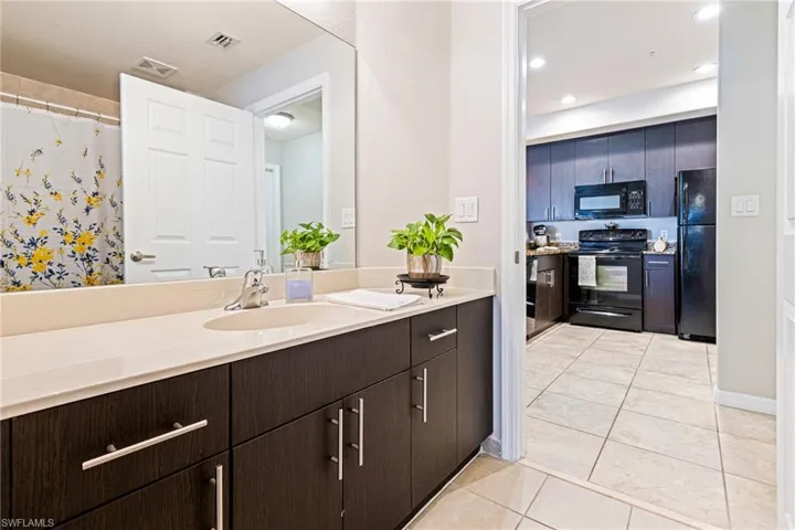 Bathroom featuring tile flooring and vanity