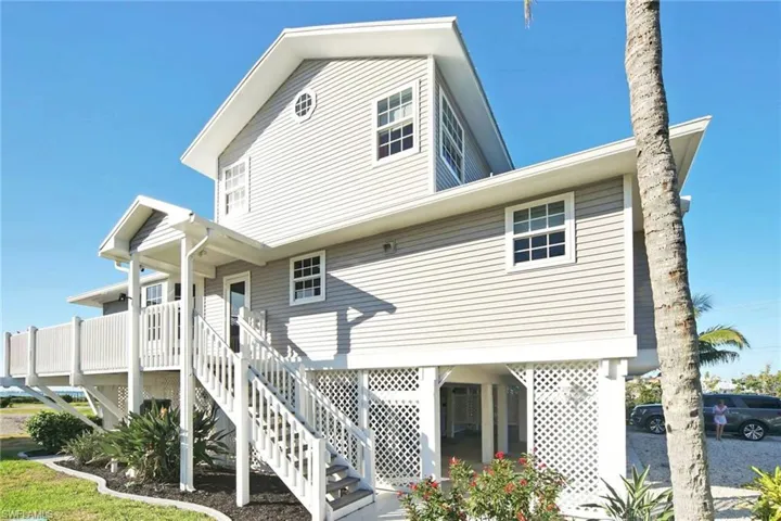Back of property featuring stairway and a deck