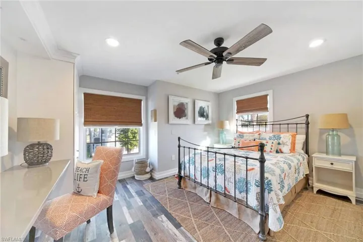 Bedroom with wood finished floors, multiple windows, recessed lighting, and ceiling fan