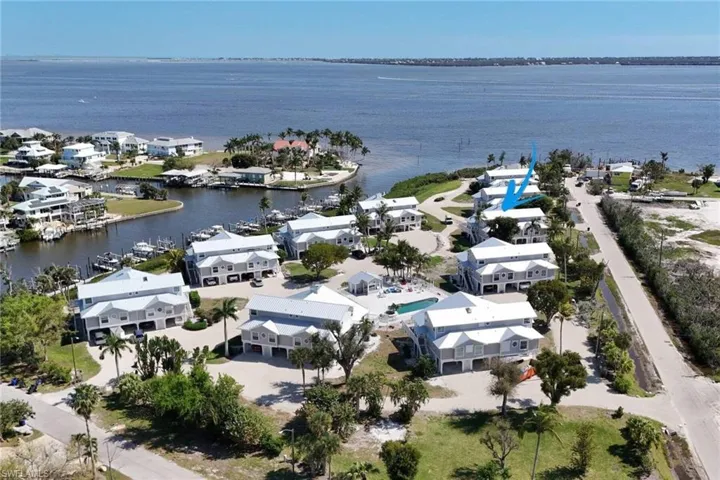 Aerial view of property's location featuring nearby suburban area and a large body of water