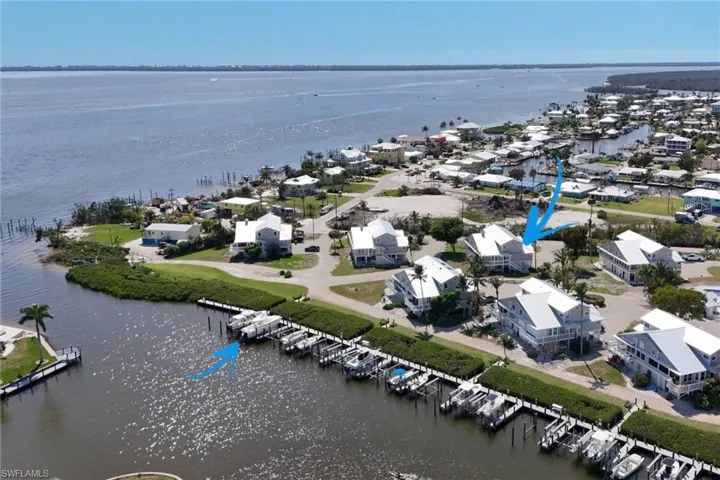 Aerial perspective of suburban area with a large body of water and a marina