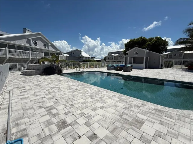 View of pool featuring a residential view, an outdoor living space, and a patio area