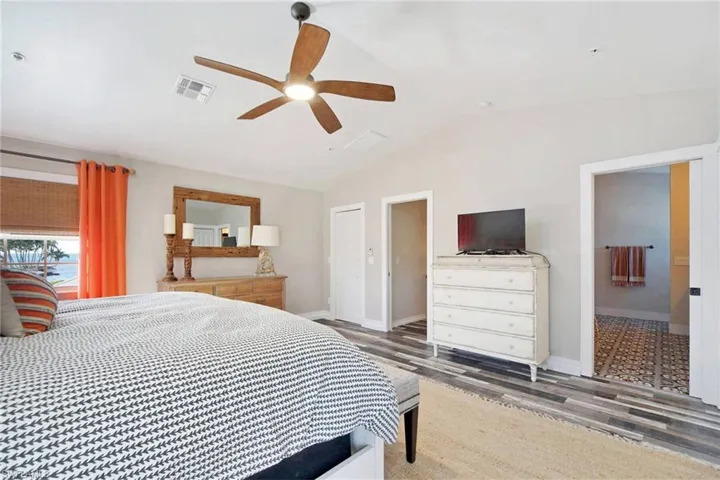 Bedroom featuring lofted ceiling, wood finished floors, and ceiling fan