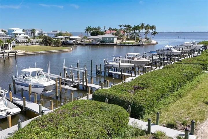Dock area featuring boat lift and a water view
