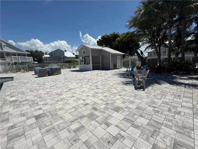 Fenced backyard with an outdoor hangout area and a residential view