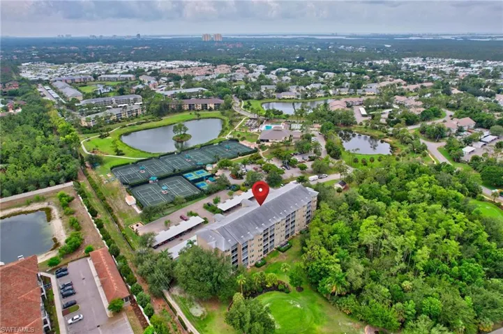 Aerial view of property and surrounding area with a nearby body of water