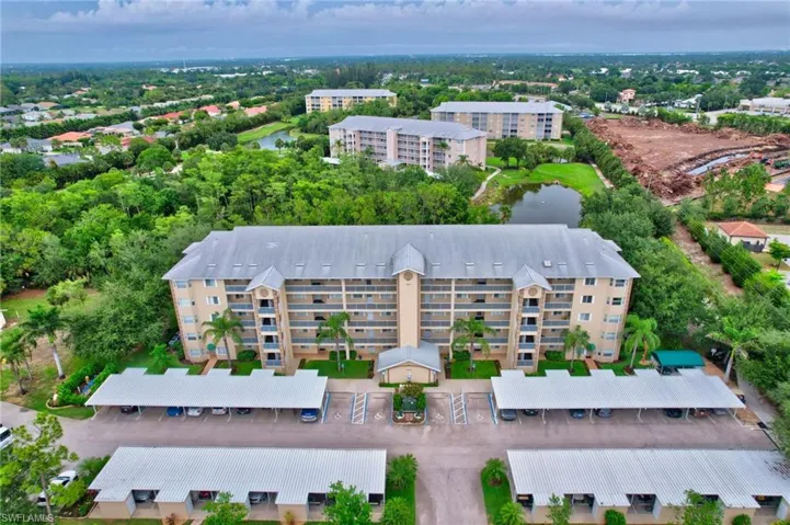Drone / aerial view of apartment complex / building and a large body of water