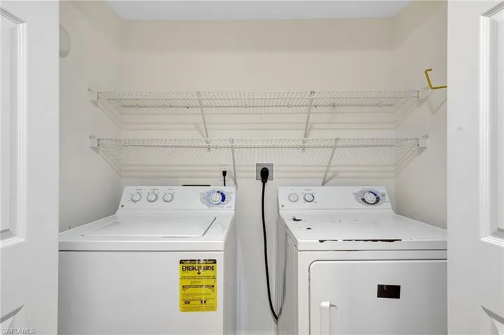 Laundry area featuring washing machine and clothes dryer
