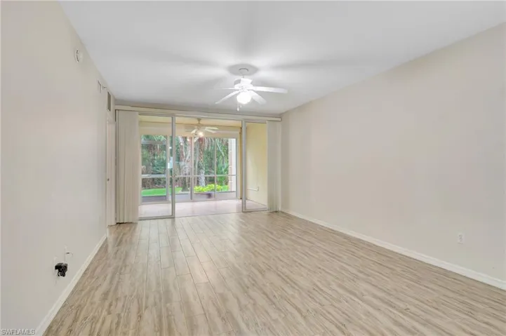 Unfurnished room featuring ceiling fan, wood finished floors, and baseboards