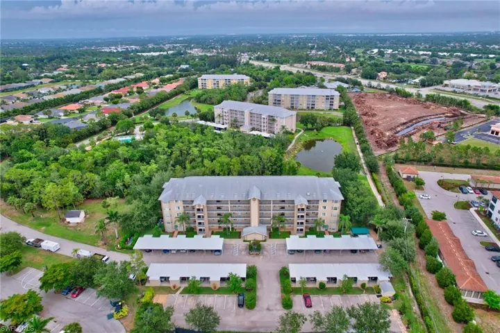 Aerial view of property's location featuring apartment complex / building and a large body of water