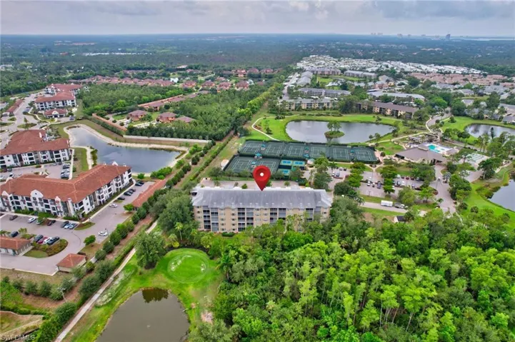 View of property location with a nearby body of water and a local golf course