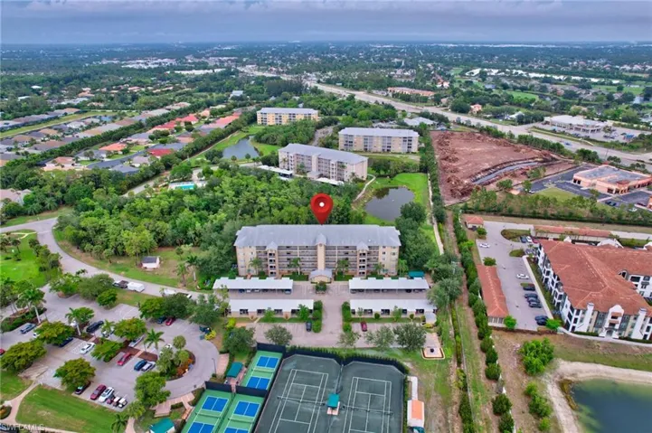 Aerial overview of property's location featuring a large body of water and apartment complex / building
